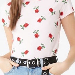 A patterned graphic tee with a pink background